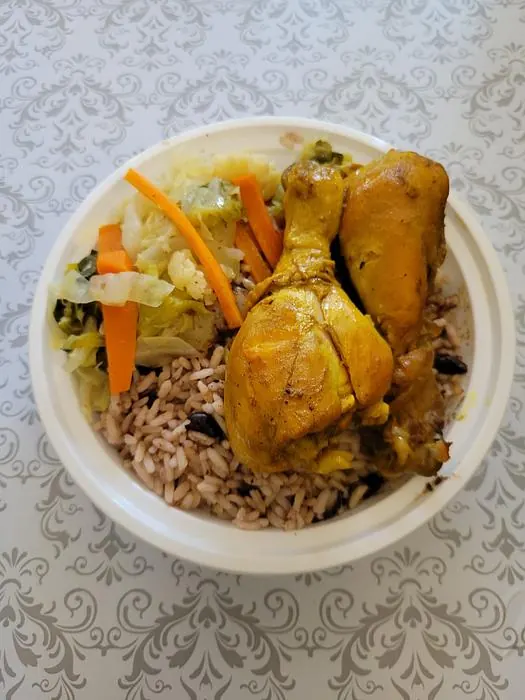 Curry chicken served with rice and steamed vegetables